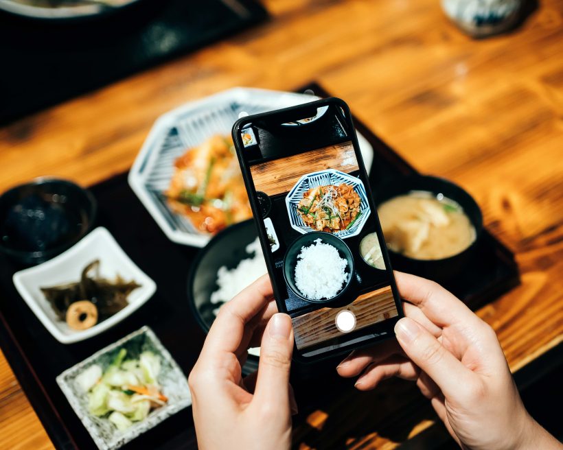 taking a picture of food for social media
